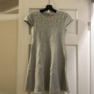 This is a gray and sparkly dress with pearls and diamonds on top.